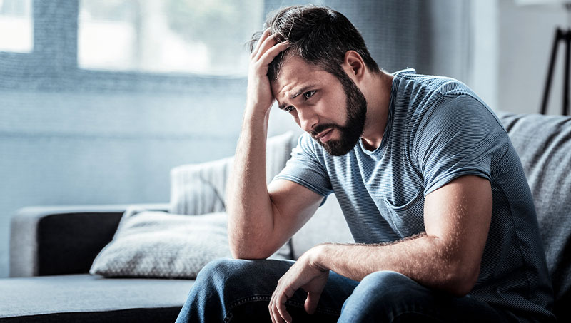 Man struggling with stress at home