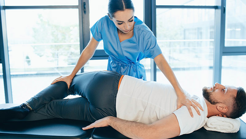 Chiropractor adjusting patient with sciatica